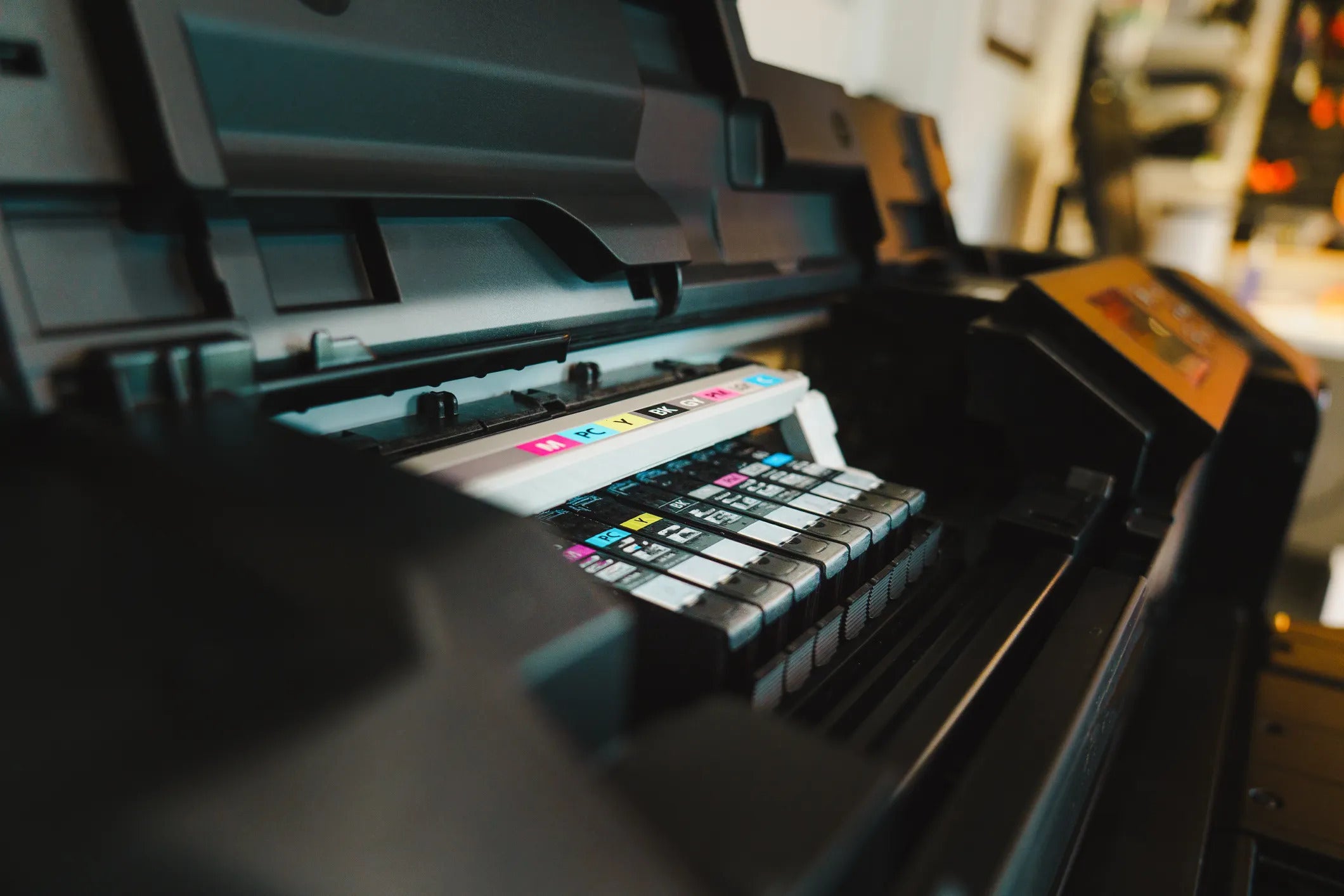 Compatible ink cartridges loaded into a Canon imagePROGRAF wide-format printer carriage